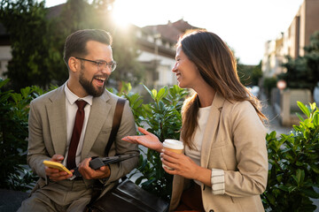 Business people having a casual conversation outdoors during coffee break