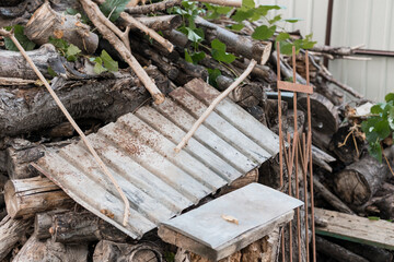 Rustic Woodpile Scene with Corrugated Metal Detail. A Brown and Gray Landscape Featuring Logs,...