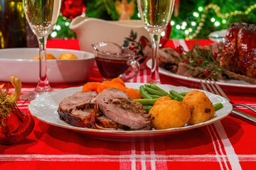 Festive Christmas dinner with stuffed duck, roast potatoes and vegetables
