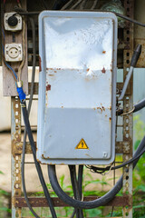 Moscow, Russia, 18.06.2025 Old rusted electrical panel with a high voltage warning sign and exposed...