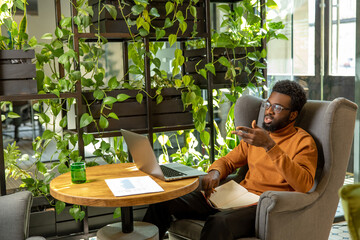 Entrepreneur man working from workspace concentrating on virtual meeting