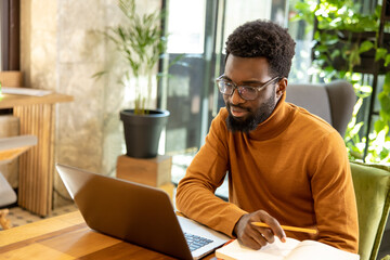 Entrepreneur man working from stylish workspace concentrating on virtual presentation