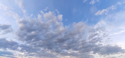 Cumulus clouds float across the sky. Beautiful photo of cloudy sky.
