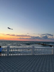 scenery from the beach to the sea with sunset clouds