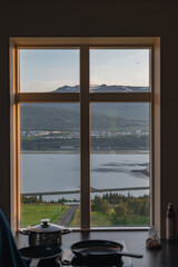 View Through a Window of Icelandic Town by Snow Capped Mountains