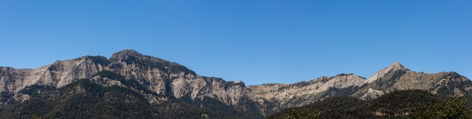 panorama mountain range under clear blue summer sky.