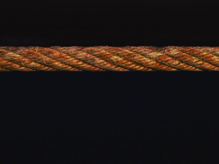 Fiery abstract rope texture on black background, stylized photo,