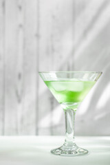 Cold green appletini cocktail in a glass