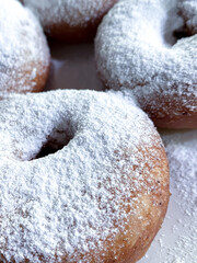 Donuts sprinkled with powdered sugar on top, 