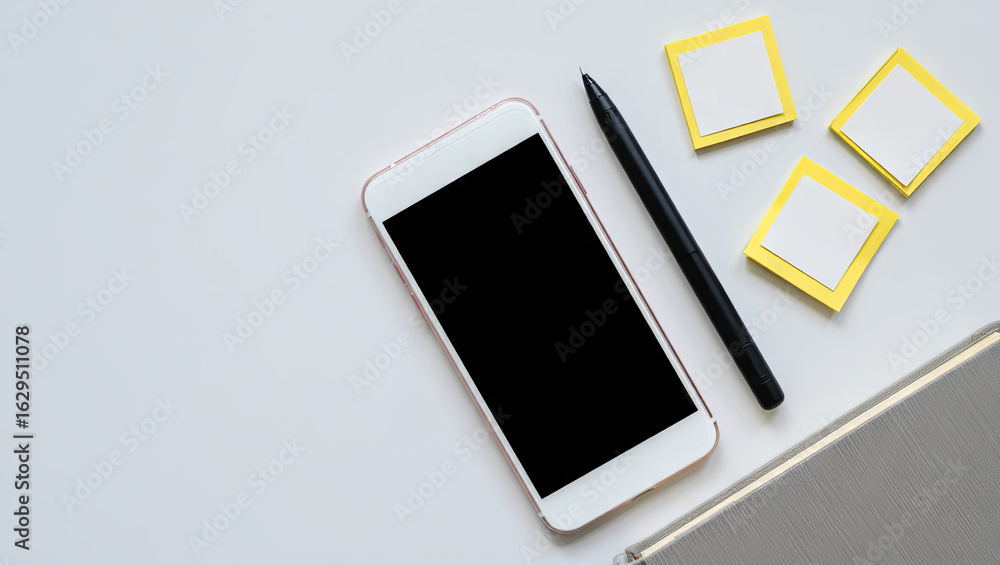Poster a workspace shows a smartphone with a black screen, a pen, and three square sticky notes. the setup 