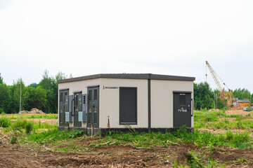 Moscow, Russia, 18.06.2025 An electrical substation building providing power to a construction site in a clearing for infrastructure development.