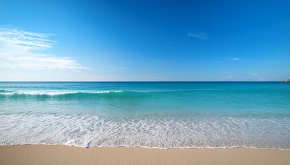 Fototapeta premium serene beach view with gentle waves and clear blue sky