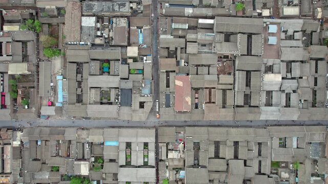 Drone view of Pingyao ancient city in Pingyao, Shanxi province, China. Aerial view of an old Asian town with traditional architecture and grey roofs, 4K real time Footage.