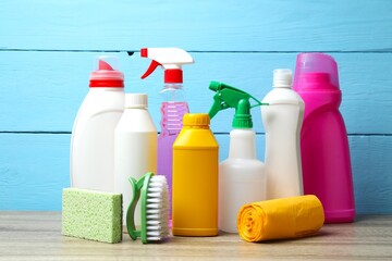 Cleaning tools on a wooden table. Perfect for cleaning, organizing, and home maintenance themes....