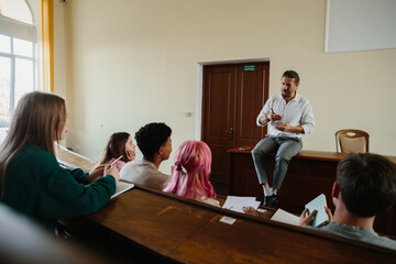Group of Students Engaged in Discussion with Lecturer in Bright Classroom