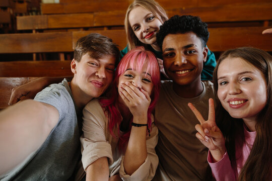 Group of Friends Celebrating and Smiling Together in a School Classroom