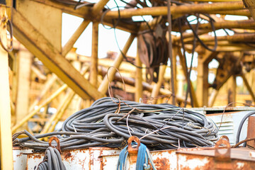 Moscow, Russia, 18.06.2025 Old electrical cable and rope on rusty metal surface of construction...
