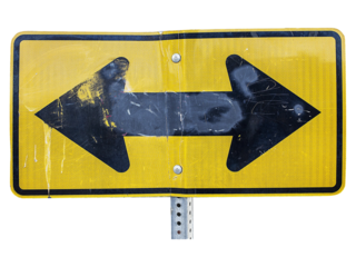 Sign of Direction: A weathered road sign displays two opposing arrows, suggesting a crossroads and a pivotal decision, embodying choices, decisions, and guidance