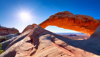stunning whitish and beige rock formation featuring an archway beneath a bright sunny sky