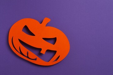 Halloween pumpkin on violet-themed area
