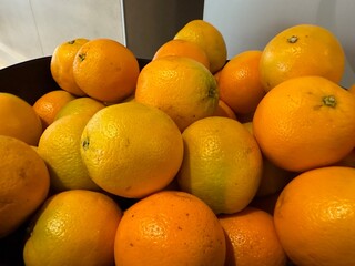 Pile of Fresh Oranges: Oranges stacked with vibrant orange, yellow, and hints of green, fresh, natural, and ready for healthy eating