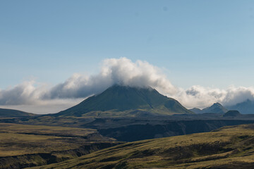 Fototapeta premium Mountain in Iceland with Low Clouds and Rugged Volcanic Terrain