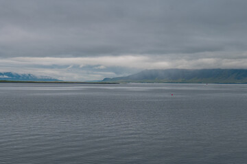 Serene Icelandic Lake with Rugged Mountains and Red Buoy