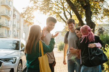 Friends Enjoying a Lively Outdoor Chat in a Sunny Urban Setting