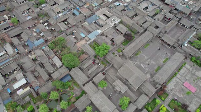 Drone view of Pingyao ancient city in Pingyao, Shanxi province, China. Aerial view of an old Asian town with traditional architecture and grey roofs, 4K real time Footage.