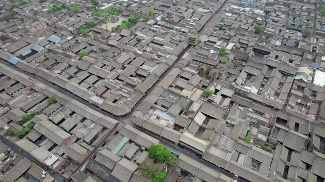 Drone view of Pingyao ancient city in Pingyao, Shanxi province, China. Aerial view of an old Asian town with traditional architecture and grey roofs, 4K real time Footage.
