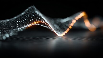 Glowing particle wave flowing above dark surface with orange light accents.