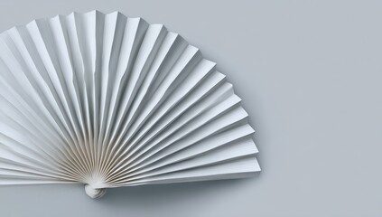 White paper fan on grey background, clean and minimalist high-resolution image.