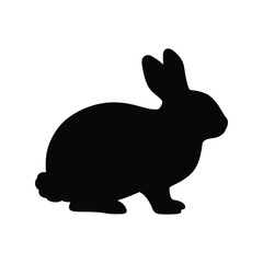 Black silhouette of a rabbit sitting and looking to the side isolated on white background