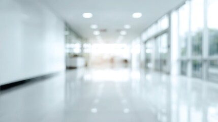 Obraz premium Blurred modern clinic corridor with white minimalist background, clean healthcare space template for medical UI design and health tech concepts.