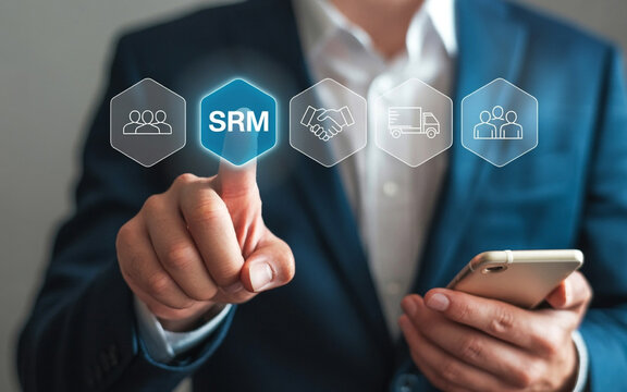 Man in blue suit touching S R M icon with business icons and phone technology hand