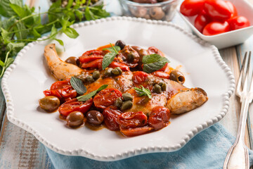 sword fish with olives capers and tomatoes