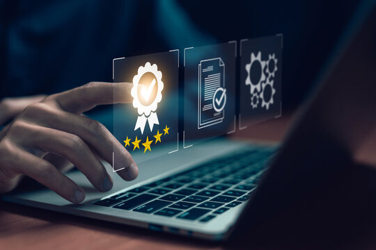 Quality assurance and digital certification concept. Business hand selecting five-star badge icon on virtual screen. Symbol of trust, verified service, high standard approval, and digital excellence.