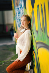 A beautiful teenage model girl posing on the streets of old town during street style photo shooting