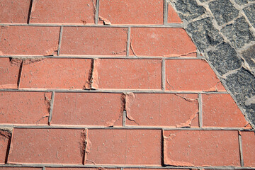 Cracked Red Pavement Tiles and Cobblestone Intersection Surface