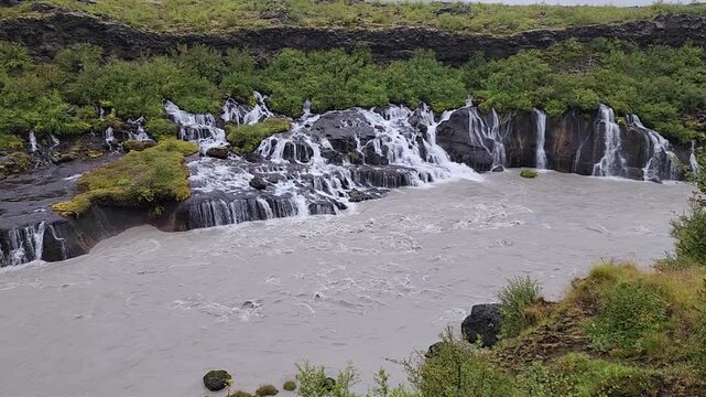 A Small but Long Waterfall Ridge Encompassing a River in Iceland