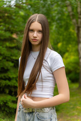 Fototapeta premium A beautiful young girl with long dark blonde hair