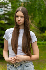 A beautiful young girl with long dark blonde hair