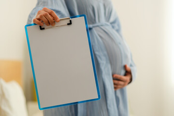 Spotless notebook in expecting mother's hands, waiting for important pregnancy notes and hospital...