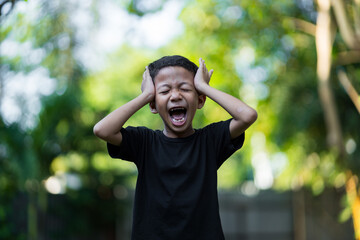 Frustrated Boy Screaming Outdoors © Rangga Ispraditya