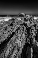 Old shipwreck in the sea close to the shore