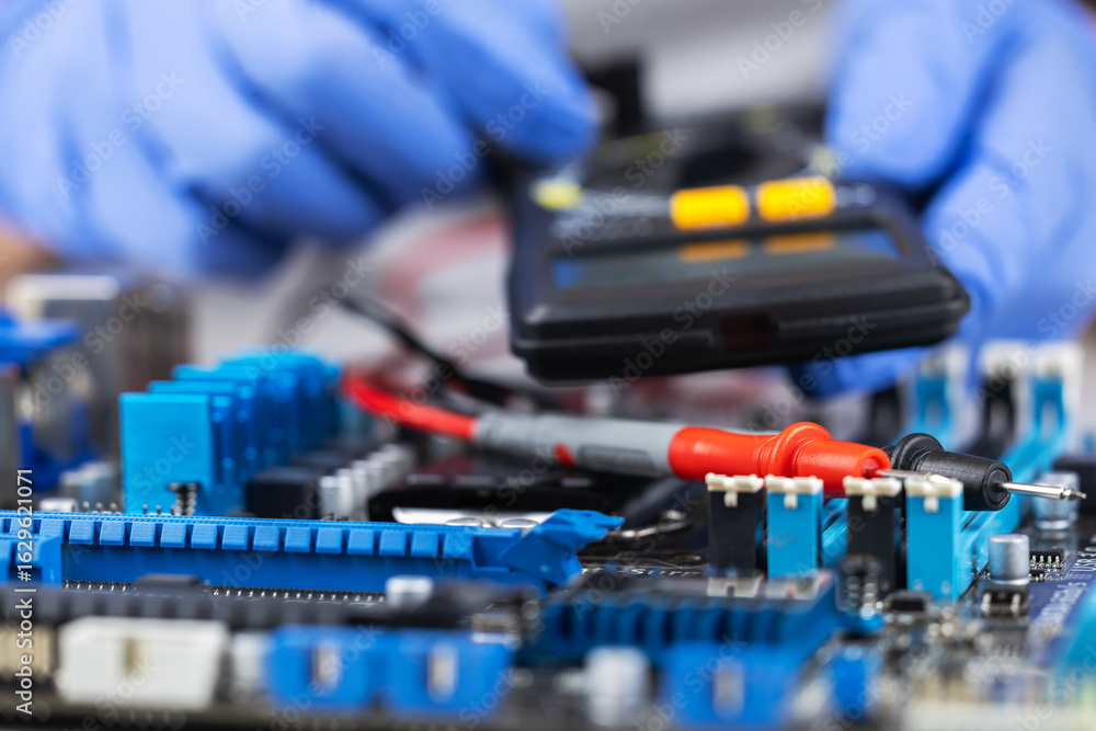 Poster testing motherboard with probes and multimeter, close-up of technician using probes on computer moth