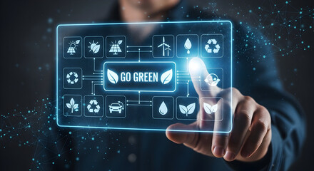 Businessman interacts with glowing futuristic interface displaying 'Go Green' and eco-friendly icons, symbolizing sustainable technology and environmental awareness.