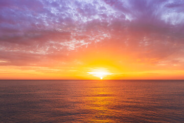 beautiful sunrise or sunset seascape with amazing calm sea water with waves and colorful amazing cloudy morning sky on background