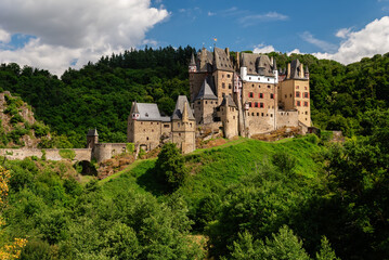 Wierschem, Germany - July 11, 2025: Eltz Castle, a historic medieval hilltop castle surrounded by lush green forests, in Wierschem, Germany
