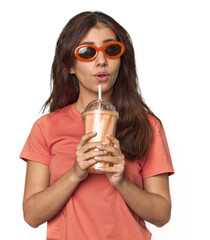 Young Middle Eastern woman with sunglasses, vanilla shake